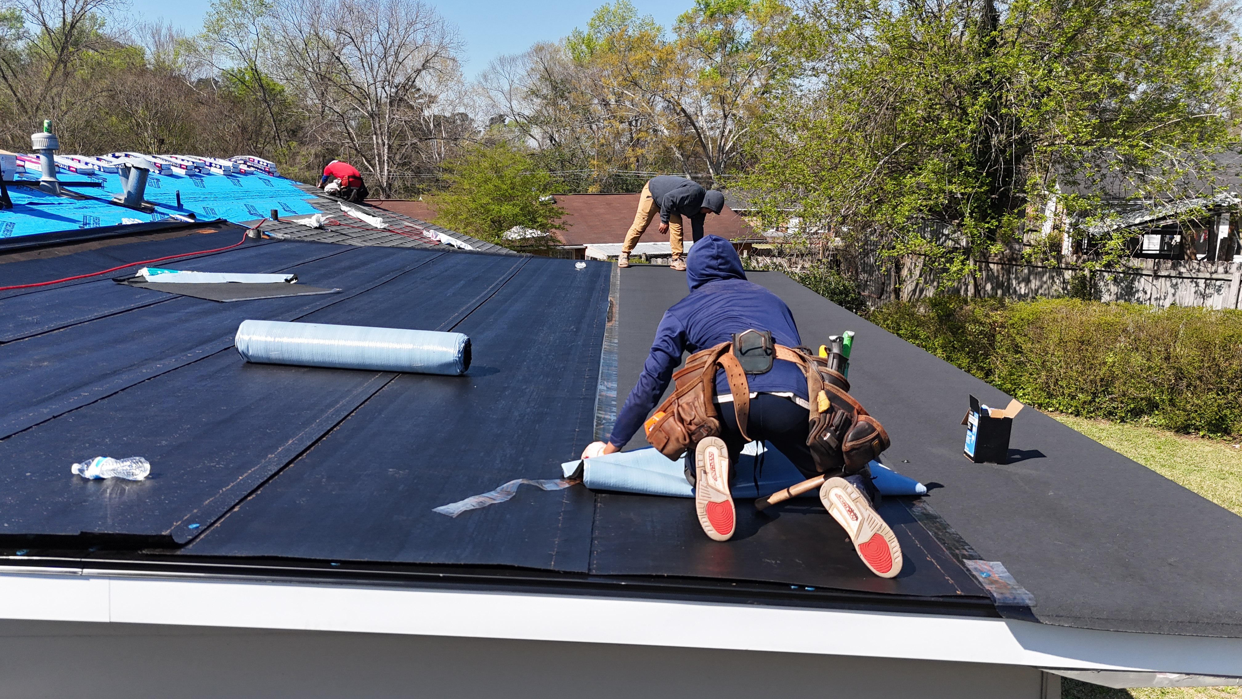 Flat roof membrane being installed